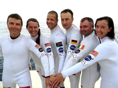 NASA astronauts wearing specialty white wetsuits made by JMJ Wetsuits